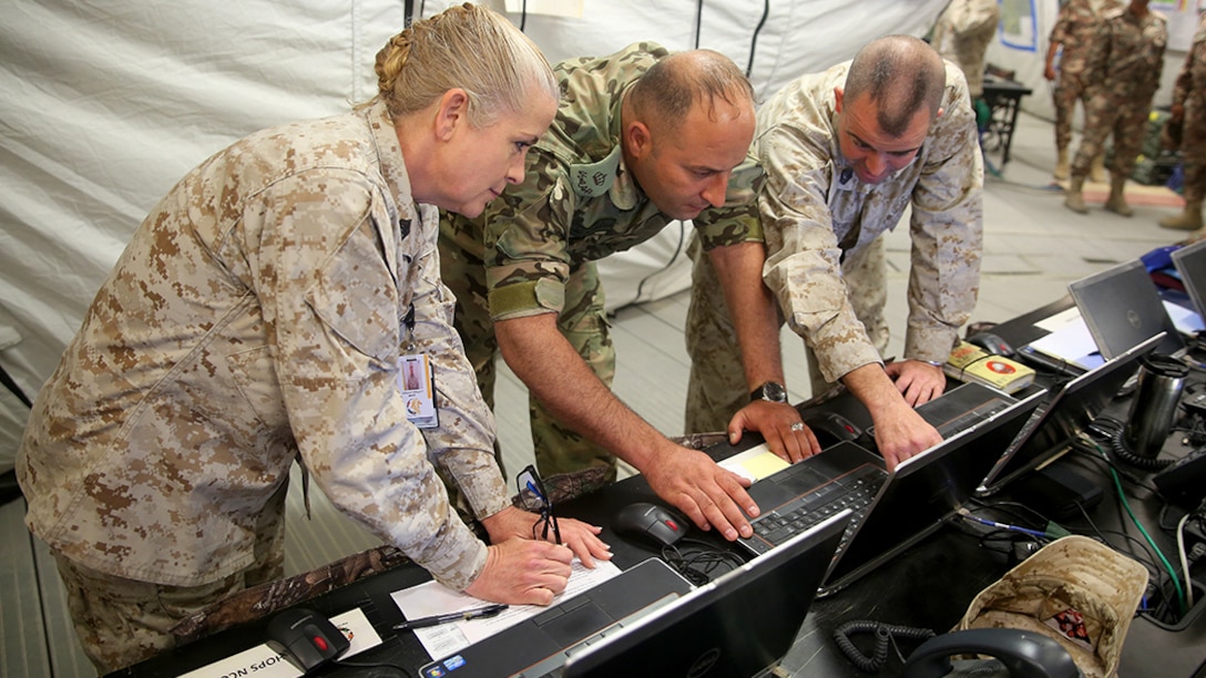Master Sgt. Michael J. Decker, Current Operations Chief, discusses the closing evolutions of Exercise Eager Lion 2016, in Amman, Jordan, May 24, with his Jordanian Armed Forces counterpart and Master Sgt. Linda K. Junjak, the Current Operations SNCOIC and Texarkana.  A new administrative order MARADMIN 016/06 allows reservists to conduct annual training in an imminent danger pay area.