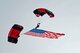 Members of the U.S. Army Special Operation Command Parachute Demonstration Team fly in the American flag, officially beginning the second day of the 2016 Shaw Air Expo and open house, “Thunder Over the Midlands,” at Shaw Air Force Base, S.C., May 22. The Black Daggers perform a number of live aerial demonstrations in support of U.S. Army special operations community relations and recruiting. (U.S. Air Force photo by Airman 1st Class Christopher Maldonado) 