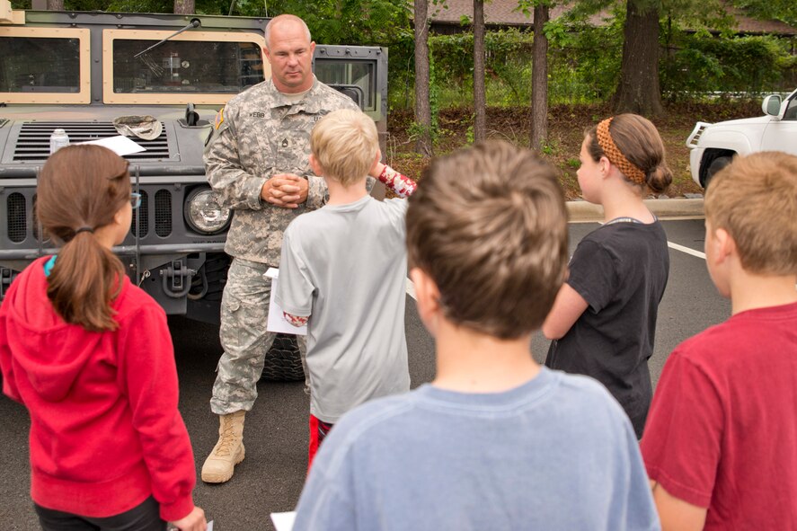 Sgt. 1st Class Michael Webb, who is assigned to Headquarters and Headquarters Company, 39th Brigade Special Troops Battalion, Arkansas Army National Guard, informs students from Julia Lee Moore Elementary School about the benefits of a career in the U.S. Military during the Fourth Grade Elementary Career Fair at the Second Baptist Church in Conway Ark., May 17, 2016. The purpose of the event was to expose students to careers they might not have considered and the level of education requirements those careers may require. (U.S. Air Force photo by Master Sgt. Jeff Walston/Released)  