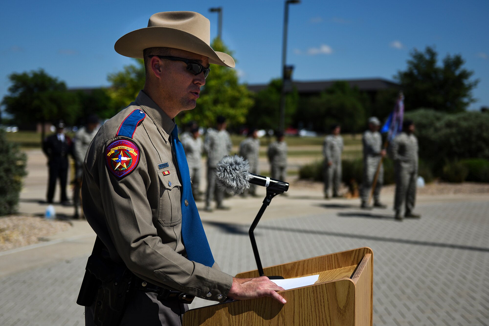 Russel Weatherby, Department of Public Safety Texas Highway Patrol and 17th Security Forces Squadron Individual Mobilization Augmentee reservist, gives a speech during a retreat ceremony for National Police Week at the Norma Brown Building on Goodfellow Air Force Base, Texas, May 20, 2016. Weatherby’s speech honored law enforcement officers who gave the ultimate sacrifice in the line of duty and paid respects to the family members of said individuals. A retreat ceremony signals the end of the duty day and serves as a ceremony for paying respects to the flag. (U.S. Air Force photo by Senior Airman Devin Boyer/Released)