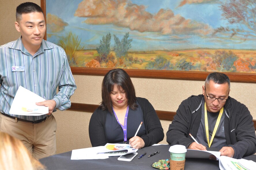 Air Force Reserve Chaplain (Maj.) Joshua Kim (left) leads Tech. Sgt. Jesse Mateo and his wife, Michelle, in a Couples Enrichment Program activity May 22, at a Yellow Ribbon Reintegration Program training event near Dallas. Yellow Ribbon promotes the well-being of reservists and their families by connecting them with resources before and after deployments. Mateo, a reservist at Andersen Air Force Base, Guam, attended one training weekend with Michelle prior to his 2015 deployment and two upon his return. (U.S. Air Force photo by Capt. Candice Allen)
