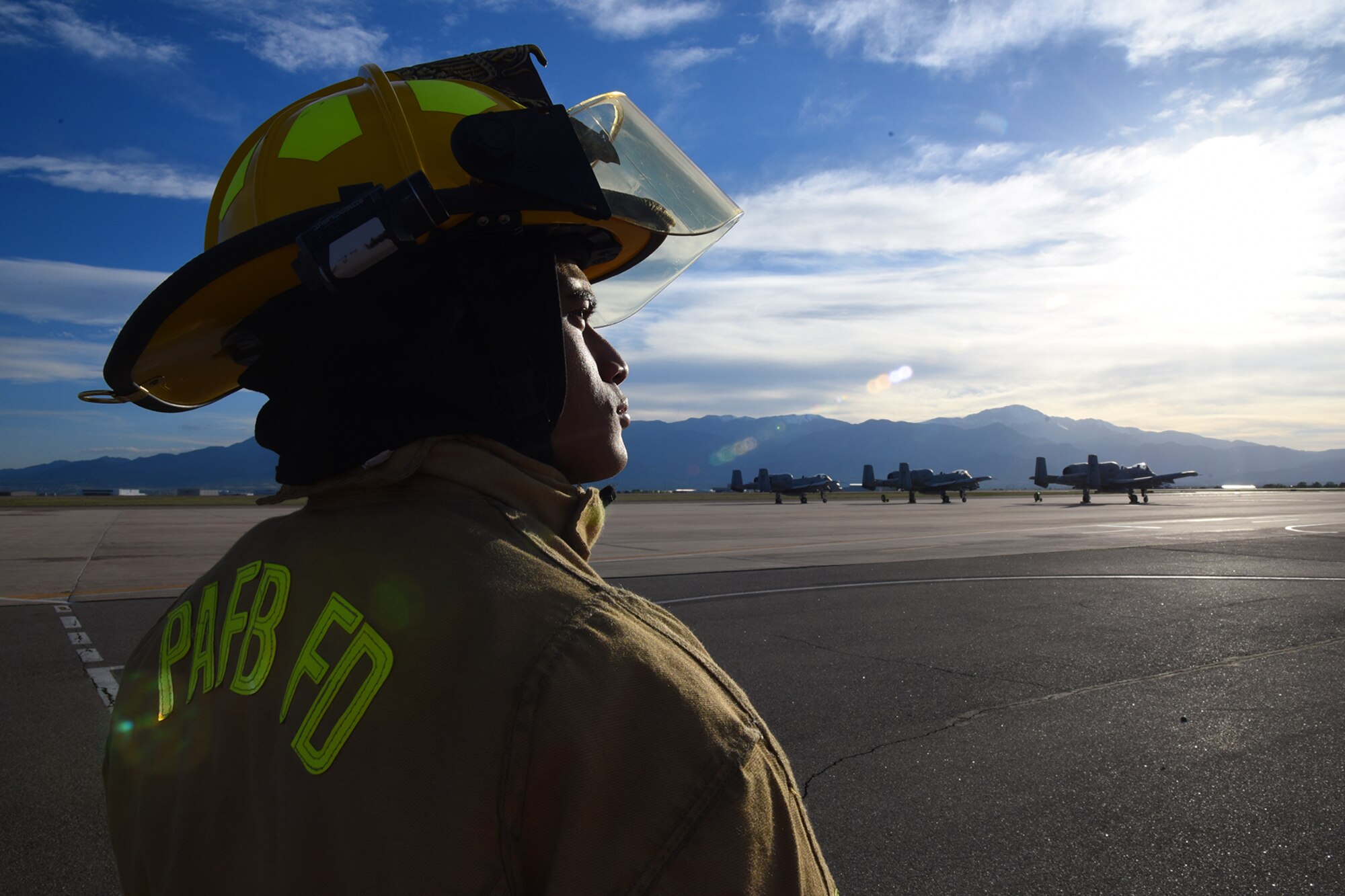 PETERSON AIR FORCE BASE, Colo. – Airman 1st Class Fred Lokan, a 21st Civil Engineer Squadron firefighter, stands on the flightline at Peterson Air Force Base, Colo., on May 21, 2016. Even though the mountains are bigger than the those in American Samoa, Lokan says they still remind him of life back on the island. (U.S. Air Force photo by Airman 1st Class Dennis Hoffman)