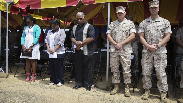 The family of Cpl. Larry Harris, along with Recruit Training Regiment leadership, listen as the RTR chaplain delivers the invocation during a dedication ceremony at Marine Corps Base Camp Pendleton May 19.  An obstacle of the Crucible was named after Cpl. Larry Harris, who was killed in action on July 1, 2010.  His citation will be read every iteration of the Crucible, ensuring his heroics and legacy will never be forgotten. 