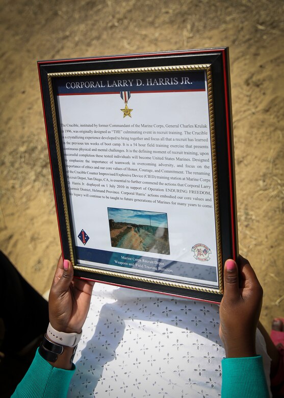 Plaques being presented during a dedication ceremony at Marine Corps Base Camp Pendleton, Calif., May 19.  An obstacle of the Crucible was named after Cpl. Larry Harris, who was killed in action on July 1, 2010.  His citation will be read every iteration of the Crucible, ensuring his heroics and legacy will never be forgotten.