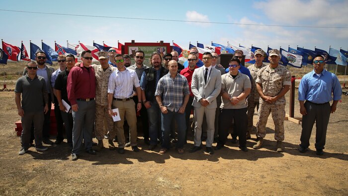 Current and former Marines of 3rd Battalion, 1st Marines who served with Cpl. Larry Harris, stand in front of his citation after a dedication ceremony honoring Harris at Marine Corps Base Camp Pendleton, Calif., May 19.  An obstacle of the Crucible was named after the Marine, who was killed in action on July 1, 2010.  His citation will be read every iteration of the Crucible, ensuring his heroics and legacy will never be forgotten.