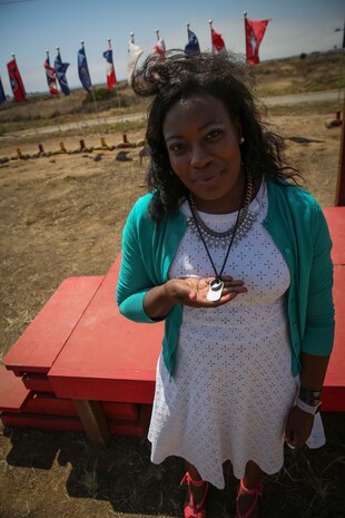 Stacia Harris, wife of Cpl. Larry Harris, displays the necklace that holds her husband’s wedding ring and dog tags after a dedication ceremony at Marine Corps Base Camp Pendleton, Calif., May. 19.  An obstacle of the Crucible was named after the Marine, who was killed in action on July 1, 2010.  His citation will be read every iteration of the Crucible, ensuring his heroics and legacy will never be forgotten.