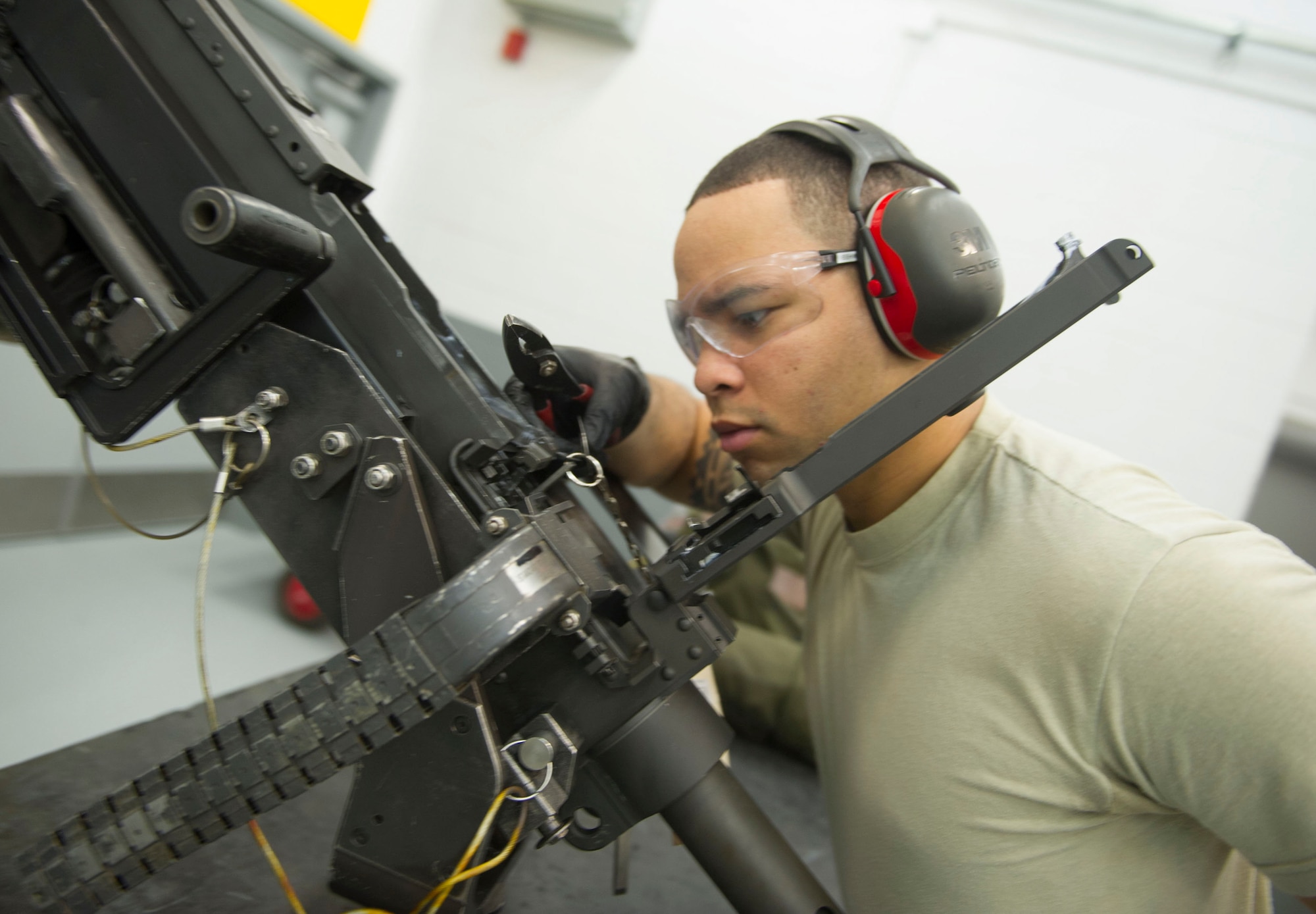 Airman 1st Class Jamir Sinex, a weapons load crew journeyman with the 801st Special Operations Aircraft Maintenance Squadron,  ensures the gun pin releases properly during a 28-day inspection of a 50-caliber machine gun at Hurlburt Field, Fla., May 17, 2016. The inspections are performed as preventive maintenance. (U.S. Air Force photo by Senior Airman Krystal M. Garrett)