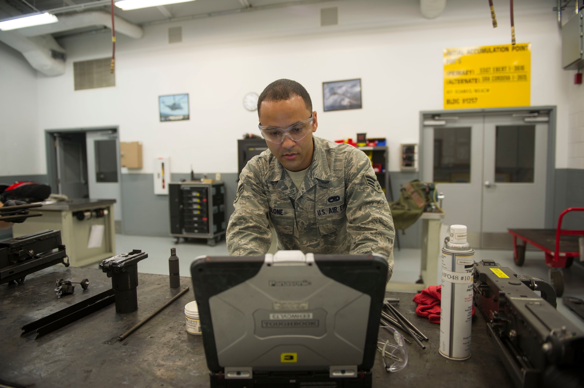 Senior Airman Benjamin DeLone, a weapons load crew journeyman with the 801st Special Operations Aircraft Maintenance Squadron,  reviews a technical order prior to performing a 28-day inspection on a 50-caliber machine gun at Hurlburt Field, Fla., May 17, 2016. A technical order is used to ensure each step of the work process is followed. (U.S. Air Force photo by Senior Airman Krystal M. Garrett) 