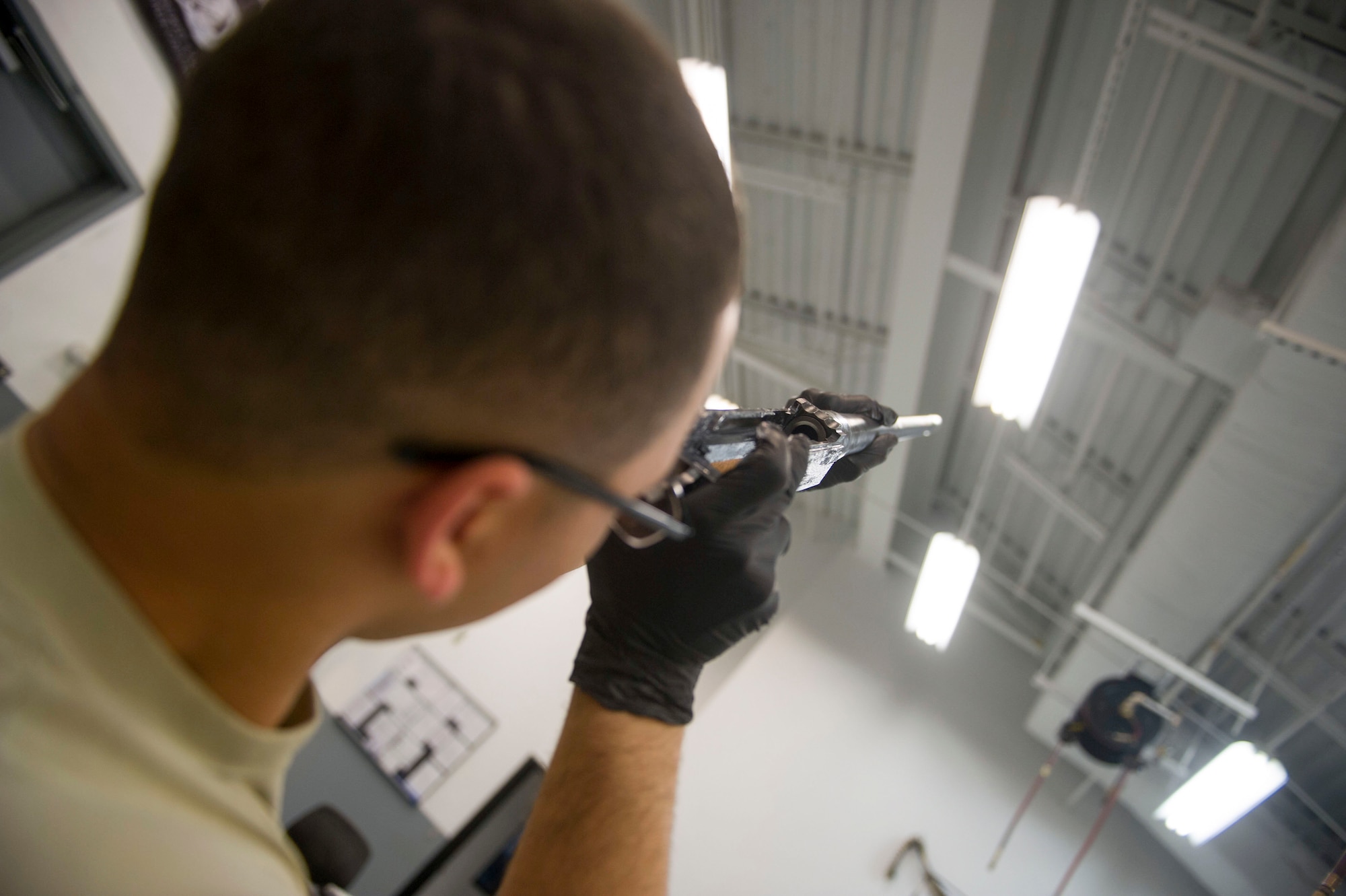 Airman 1st Class Jamir Sinex, a weapons load crew journeyman with the 801st Special Operations Aircraft Maintenance Squadron, checks the barrel of a 50-caliber machine gun during a 28-day inspection at Hurlburt Field, Fla., May 17, 2016. The inspections are performed as preventive maintenance. (U.S. Air Force photo by Senior Airman Krystal M. Garrett)