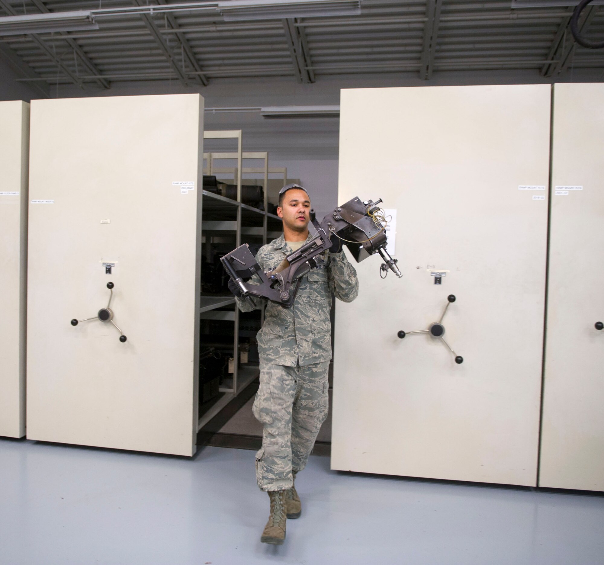 Senior Airmen Benjamin DeLone and Airman 1st Class Jamie Sinex, weapons load crew members with the 801st Special Operations Aircraft Maintenance Squadron, carries a cradle during a 28-day inspection of a 50-caliber machine gun at Hurlburt Field, Fla., May 17, 2016. The inspections are performed as preventive maintenance. (U.S. Air Force photo by Senior Airman Krystal M. Garrett)