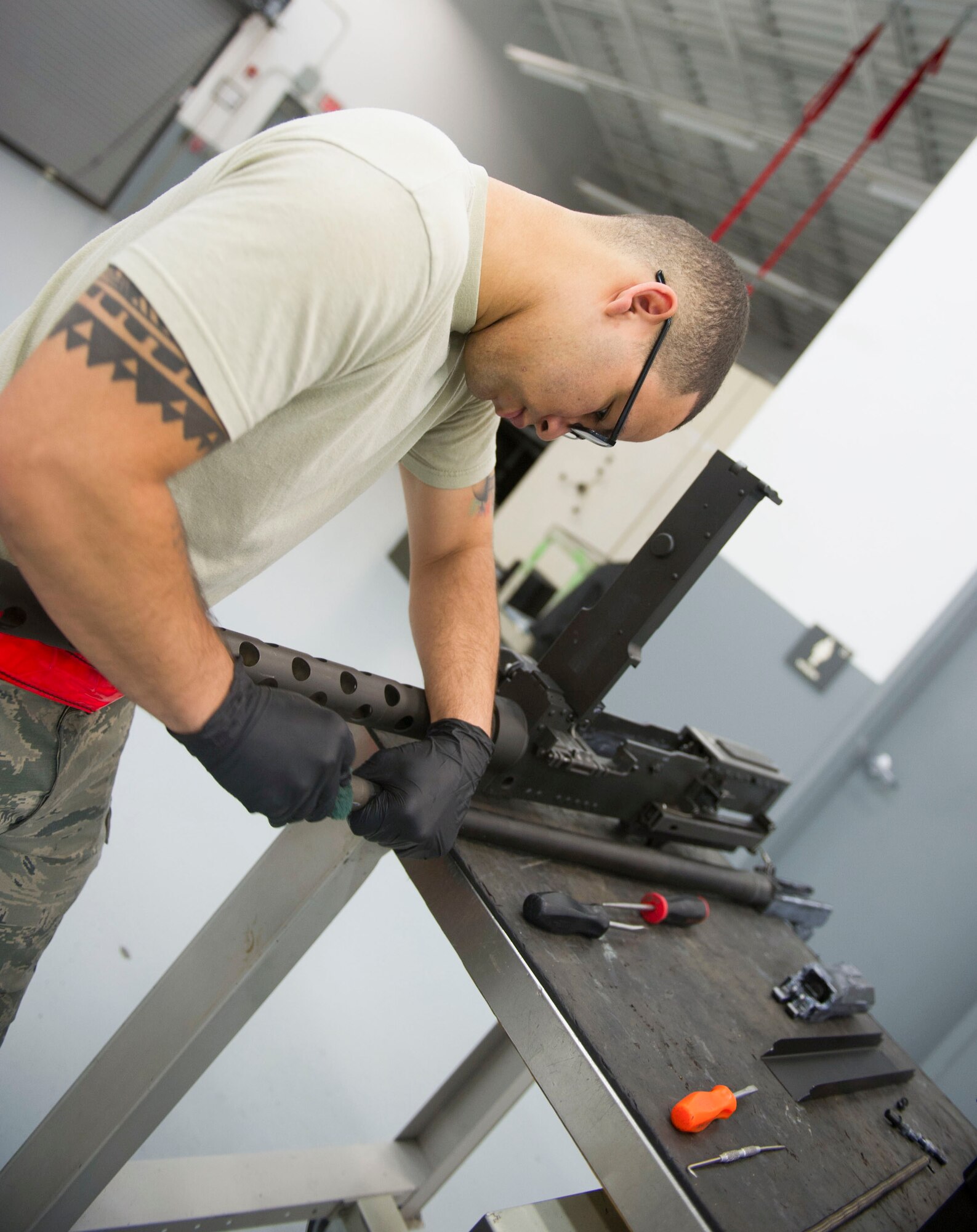 Airman 1st Class Jamir Sinex, a weapons load crew journeyman with the 801st Special Operations Aircraft Maintenance Squadron, wipes down a 50-caliber gun during a 28-day inspection at Hurlburt Field, Fla., May 17, 2016. Every 28 days the weapons systems are taken apart, checked, lubricated and put back together. (U.S. Air Force photo by Senior Airman Krystal M. Garrett) 
