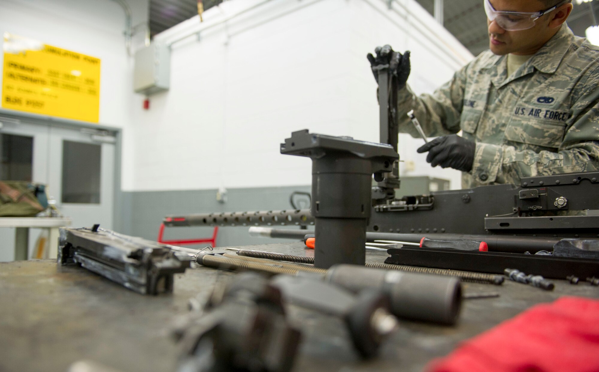 Parts of a 50-caliber machine gun lay on a table after being taken apart and lubricated at Hurlburt Field, Fla., May 17, 2016. Every 28 days the weapons systems are taken apart, checked, lubricated and put back together. (U.S. Air Force photo by Senior Airman Krystal M. Garrett) 