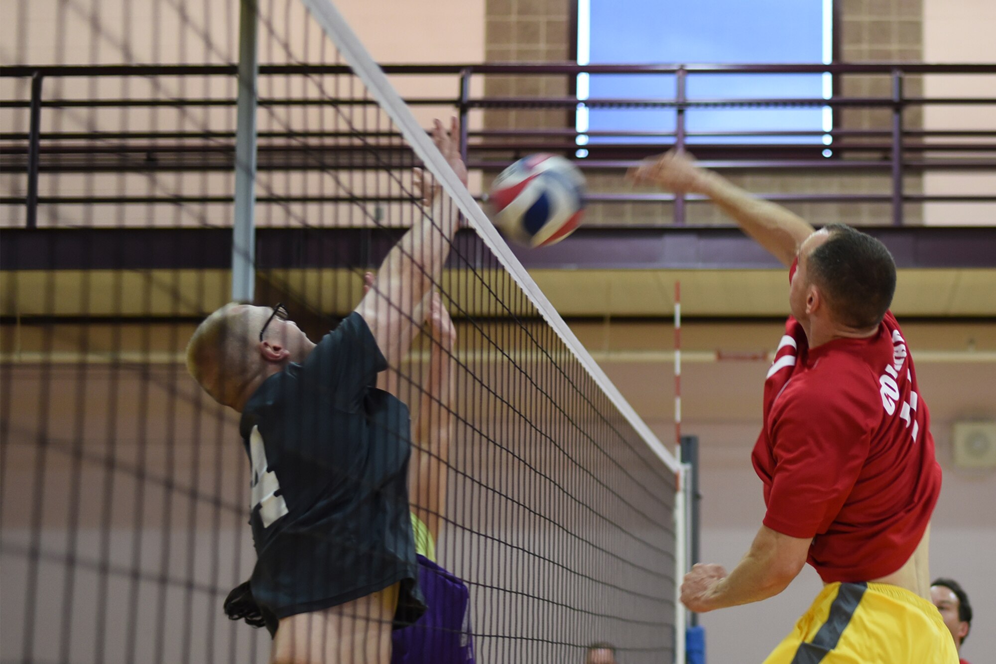 PETERSON AIR FORCE BASE, Colo. – The NORAD/U.S. Northern Command team attempts to score on the 21st Space Wing Staff Agency intramural volleyball team in the Fitness Center Gym at Peterson Air Force Base, Colo., on May 18, 2016. Although they lost the match, the NORAD/U.S. Northern Command intramural volleyball lunch league team had been dominant in their respective league, winning the past six seasons in a row. (U.S. Air Force photo by Airman 1st Class Dennis Hoffman)