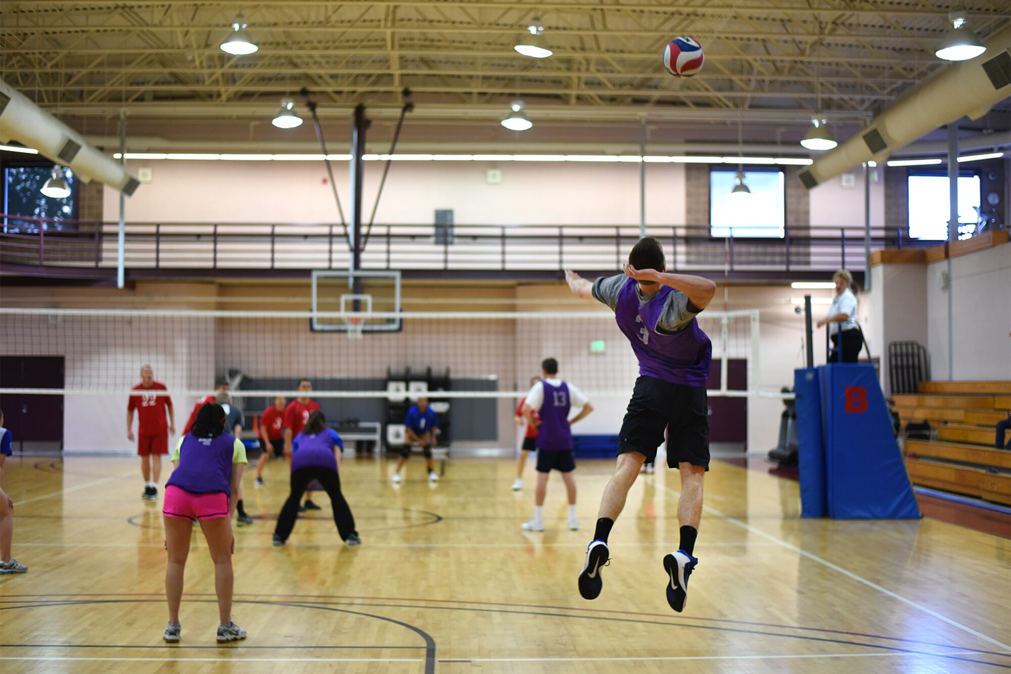 PETERSON AIR FORCE BASE, Colo. – The 21st Space Wing Staff Agency intramural volleyball team serves the volleyball to the NORAD/U.S. Northern Command intramural volleyball team in the Peterson Fitness Center on May 18, 2016. The WSA team won three consecutive games to win the match. (U.S. Air Force photo by Airman 1st Class Dennis Hoffman)