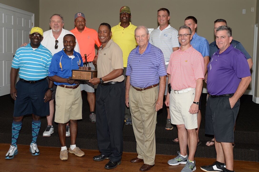 Maj. Gen. Craig Crenshaw (third from left), commanding general, Marine Corps Logistics Command, and Col. James C. Carroll (second from left), commanding officer, Marine Corps Logistics Base Albany, show off the ‘coveted’ Salty Sandbagger trophy after the Marine Corps’ victory, April 25.  The Salty Sandbagger Golf Tournament is a twice yearly friendly competition between the Marine base and the Albany Area Chamber of Commerce’s business community. 