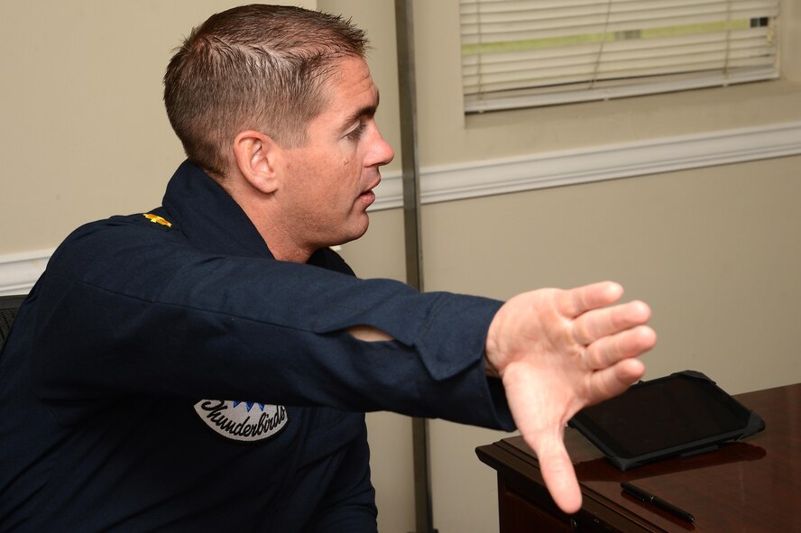 U.S. Air Force Maj. Kevin Walsh, U.S. Air Force Air Demonstration Squadron director of operations, uses his hand to demonstrate a maneuver the F-16 Fighting Falcon would fly during a pre-flight briefing at Shaw Air Force Base, S.C., May 17, 2016. Walsh flew Christopher Geddings, Sumter City fire department engineer, as the hometown hero for the Shaw Air Expo and open house. (U.S. Air Force photo by Senior Airman Jonathan Bass)