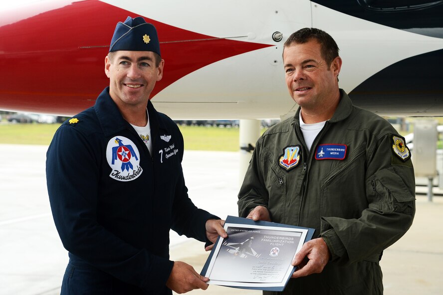 Christopher Geddings, Sumter City fire department engineer, receives his Thunderbird familiarization flight certificate from U.S. Air Force Maj. Kevin Walsh, U.S. Air Force Air Demonstration Squadron director of operations, after his hometown hero flight at Shaw Air Force Base, S.C., May 20, 2016. Geddings flew in the backseat of an F-16 Fighting Falcon with Walsh as part of the Thunderbirds hometown hero program, honoring local civilians for their dedication to their community. (U.S. Air Force photo by Senior Airman Jonathan Bass)