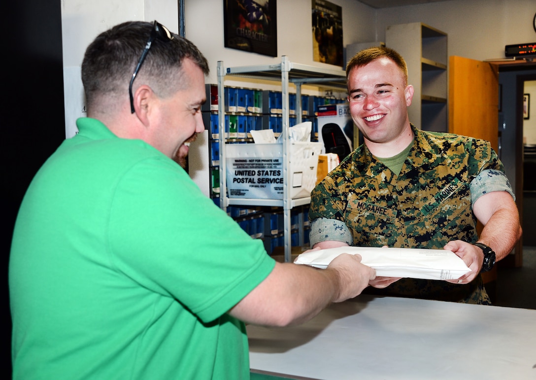 Staff Sgt. Steven McGahee, postal clerk, Marine Corps Logistics Base Albany, assists a customer at the installation’s mailroom, May 12. McGahee was meritoriously promoted to his current rank recently after winning the final meritorious promotion board at Marine Corps Installations Command.