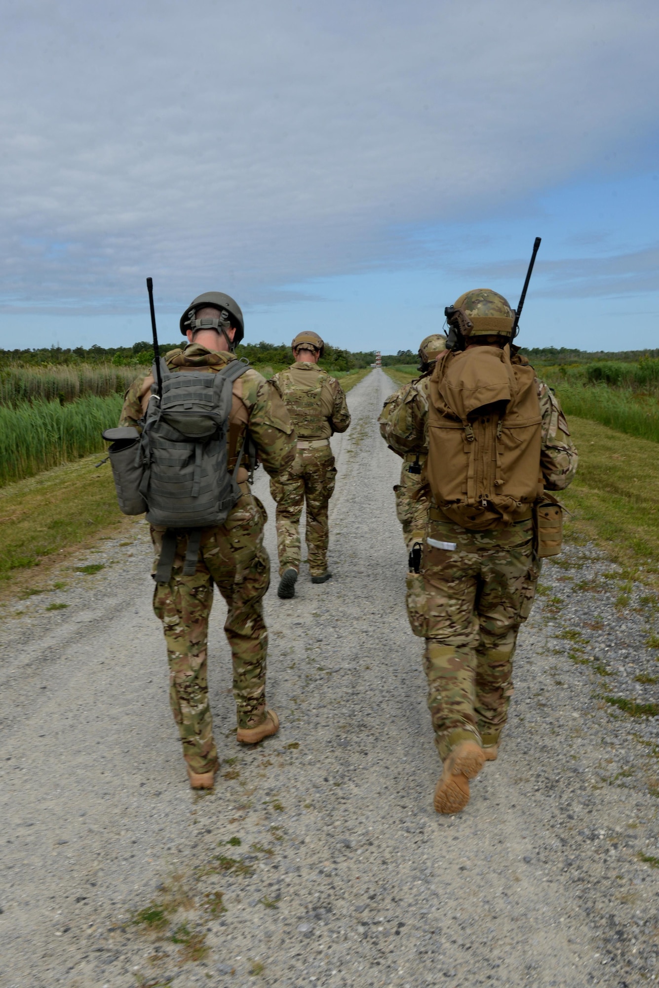 Joint terminal attack controllers, assigned to the 25th Air Support Operations Squadron, hike to a control tower during exercise Razor Talon, May 20, 2016, at Dare County Bombing Range, North Carolina. Their goal was to train in an anti-access/area denial scenario, to utilize the full combat capability of the 25th ASOS to include JTACs, joint fires observers and air support operations center personnel. (U.S. Air Force photo by Airman 1st Class Ashley Williamson/Released)