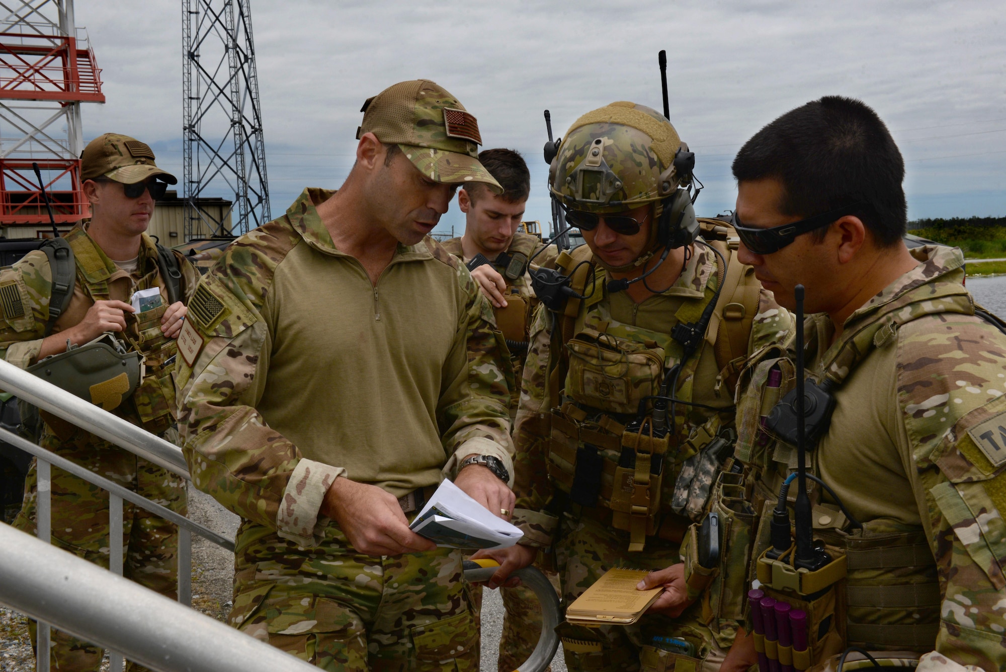 Lt. Col. James Ladd (second from left), 25th Air Support Operations Squadron director of operations, debriefs a joint terminal attack controller team after exercise Razor Talon, May 20, 2016, at Dare County Bombing Range, North Carolina. ASOS relies on personal relationships with squadron or wing leadership to receive support for JTAC training requirements. (U.S. Air Force photo by Airman 1st Class Ashley Williamson/Released)