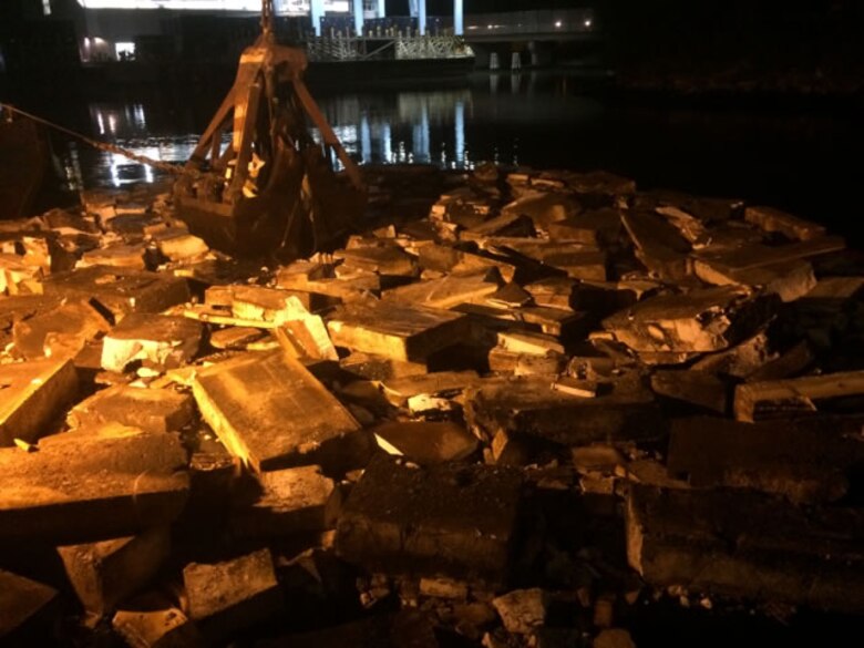 Night time operations for the removal of derelict barges and styrofoam from Flushing Bay. 