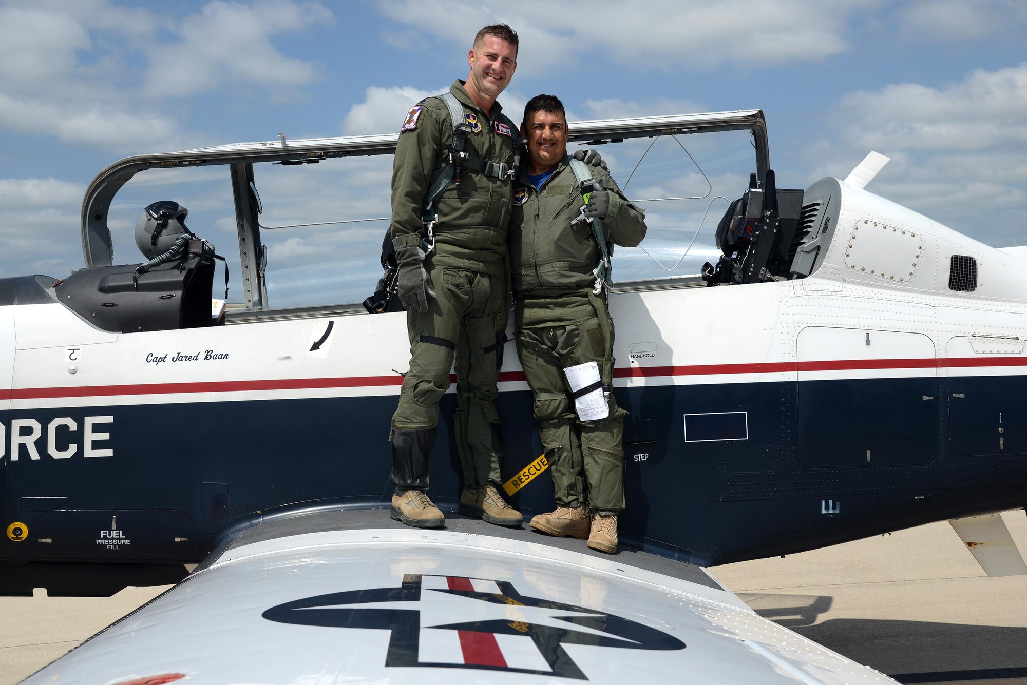 Lt. Col. Robert Moschella, 434th Flying Training Squadron commander poses for a photo with Jorge Hernandez, 47th Maintenance Directorate T-6 Texan II A-Cell crew chief, following an orientation flight, on Laughlin Air Force Base, Texas, May 20, 2016. Hernandez was awarded the first ever “Crew Chief of the Quarter” award for going above and beyond the call of duty. (U.S. Air Force photo/Airman 1st Class Brandon May)
