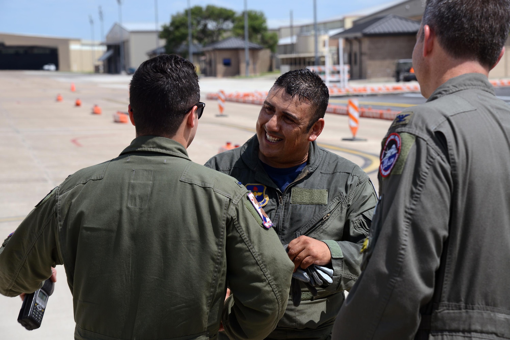 Jorge Hernandez, 47th Maintenance Directorate T-6 Texan II A-Cell crew chief, is congratulated by members of the 434th Flying Training Squadron following an orientation flight on Laughlin Air Force Base, Texas, May 20, 2016. Hernandez was awarded the first ever “Crew Chief of the Quarter” award for going above and beyond the call of duty. (U.S. Air Force photo/Airman 1st Class Brandon May)