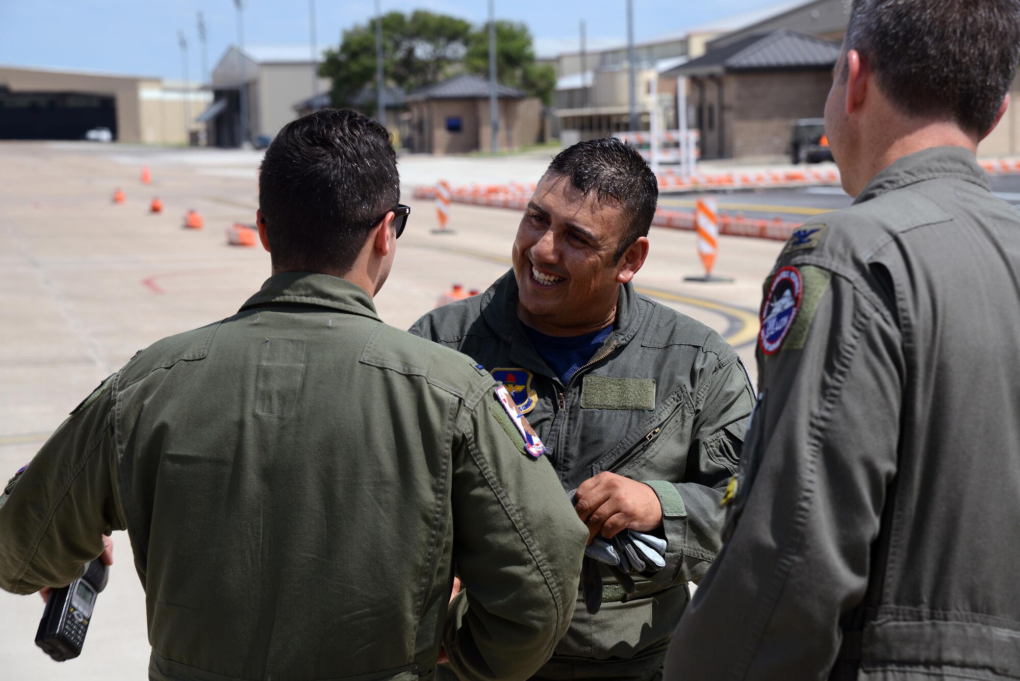 Jorge Hernandez, 47th Maintenance Directorate T-6 Texan II A-Cell crew chief, is congratulated by members of the 434th Flying Training Squadron following an orientation flight on Laughlin Air Force Base, Texas, May 20, 2016. Hernandez was awarded the first ever “Crew Chief of the Quarter” award for going above and beyond the call of duty. (U.S. Air Force photo/Airman 1st Class Brandon May)