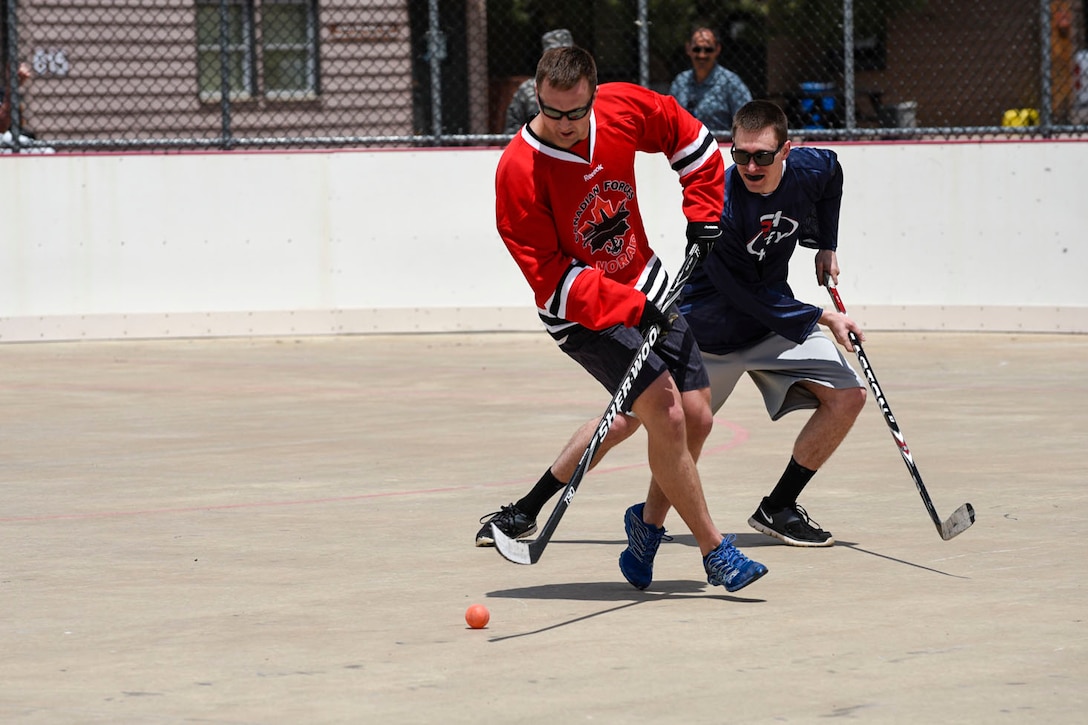 First Lt. Adam Berheide, 21st Medical Support Squadron medical readiness flight commander, chases a Canadian player to get the ball back during the 3rd Annual Canada versus U.S.A. Ball Hockey Game on May 20, 2016 at the Peterson Air Force Base, Colo., Roller Hockey Rink. American service members from the 21st Space Wing and local mission partners competed against Canadian military personnel stationed in the Colorado Springs area. Canada won the game with a score of 4-3. (U.S. Air Force photo by Senior Airman Rose Gudex)