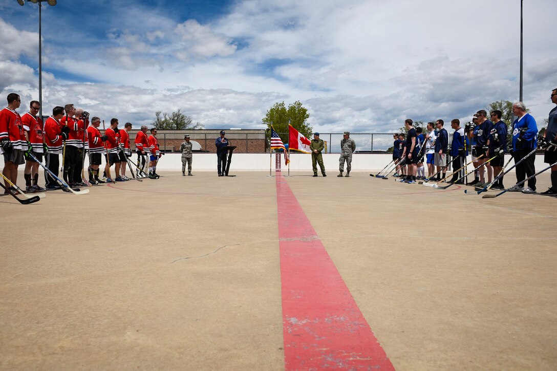 Bob Orwig, 21st Space Wing Protocol chief, explains the game details before the 3rd Annual Canada versus U.S.A. Ball Hockey Game at the Peterson Air Force Base, Colo., Roller Hockey Rink on May 20, 2016. Canada took home the trophy for the third year running, beating the Americans 4-3. The game brought together mission partners in a friendly game to encourage camaraderie and sportsmanship. (U.S. Air Force photo by Senior Airman Rose Gudex)