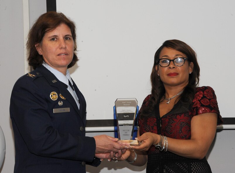 Col. Andrea Tullos, 42nd Air Base Wing commander, receives the Noel F. Parrish Memorial Trophy during the second annual Legends of Aviation Award Ceremony, May 20, 2016, Tuskegee, Ala. The honor is awarded to distinguished individuals who demonstrate a high standard of leadership. (U.S. Air Force photo/ Airman 1st Class Alexa Culbert)