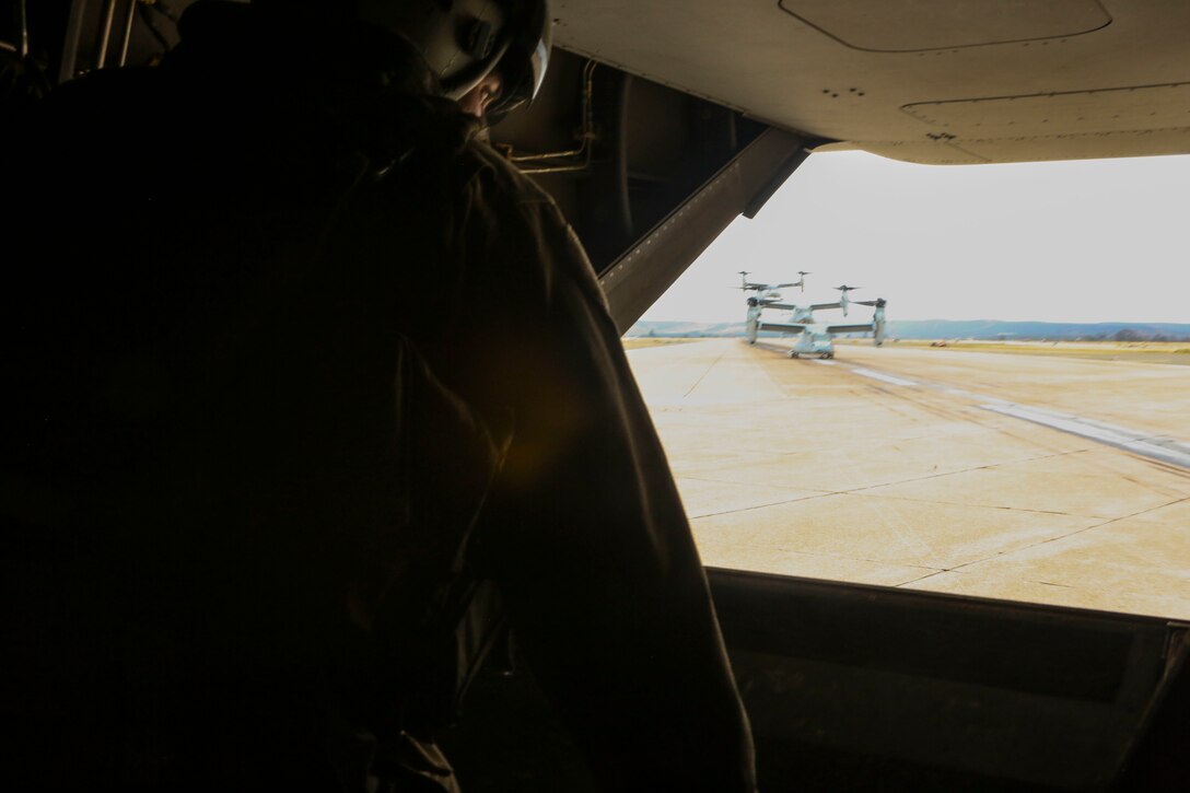 Cpl. Matthew Maenner, a crew chief with Marine Medium Tiltrotor Squadron (VMM) 163 (Reinforced), observes the other MV-22B Ospreys returning from Marine Corps Base Camp Pendleton and landing aboard Marine Corps Air Station Miramar, Calif., May 17. Marines with VMM-163 (Rein.) supported the 11th Marine Expeditionary Unit during a simulated raid and supplied four MV-22B Ospreys, two AH-1W Cobras, two UH-1Y Hueys and one CH-53E Super Stallion. (U.S. Marine Corps photo by Lance Cpl. Harley Robinson/Released)