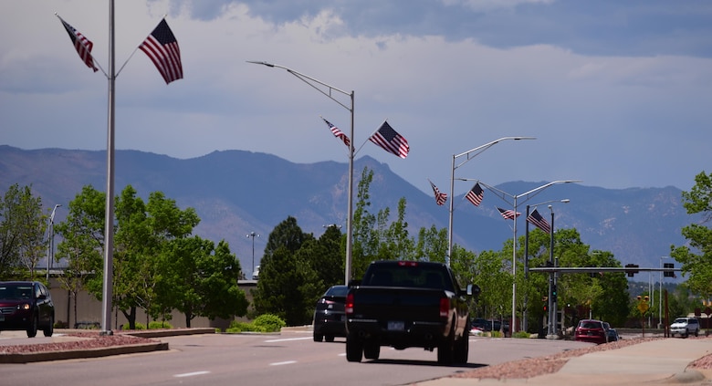American Flags line Stewart Avenue of Peterson Air Force Base, Colo. on May 23, 2016. The 21st Civil Engineer Squadron has placed roughly 130 American Flags out across the base for the upcoming Memorial Day weekend. (U.S. Air Force photo by Staff Sgt. Amber Grimm)