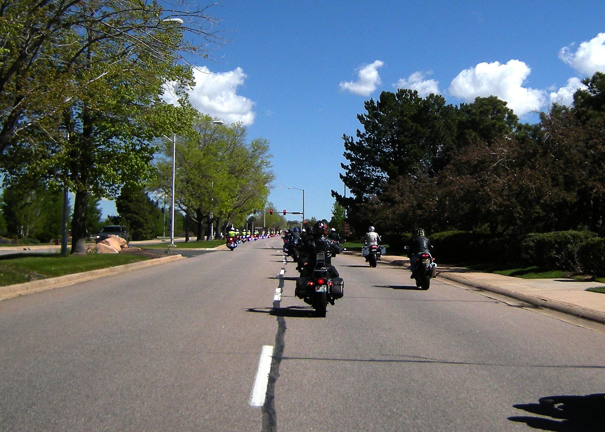 With a full escort by the Colorado Springs Police Department Motorcycle Unit, riders cruise north on Peterson Boulevard during the National Police Week Pikes Peak Fallen Officers Ride on May 19, 2016. Hosted by the Cheyenne Mountain Air Force Station's 721st Security Forces Squadron, this is the third year of the annual event in remembrance of all fallen police officers; military and civilian. (U.S. Air Force photo by Rob Bussard)