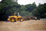 U.S. Marine Corps Marines observe Airmen operating heavy equipment during a two day joint airfield damage repair exercise May 18, 2016 at Kadena Air Base, Japan. Airmen demonstrated the method and technique the U.S. Air Force uses for airfield damage repair the first day of the exercise and the Marines applied those techniques during the second day. 