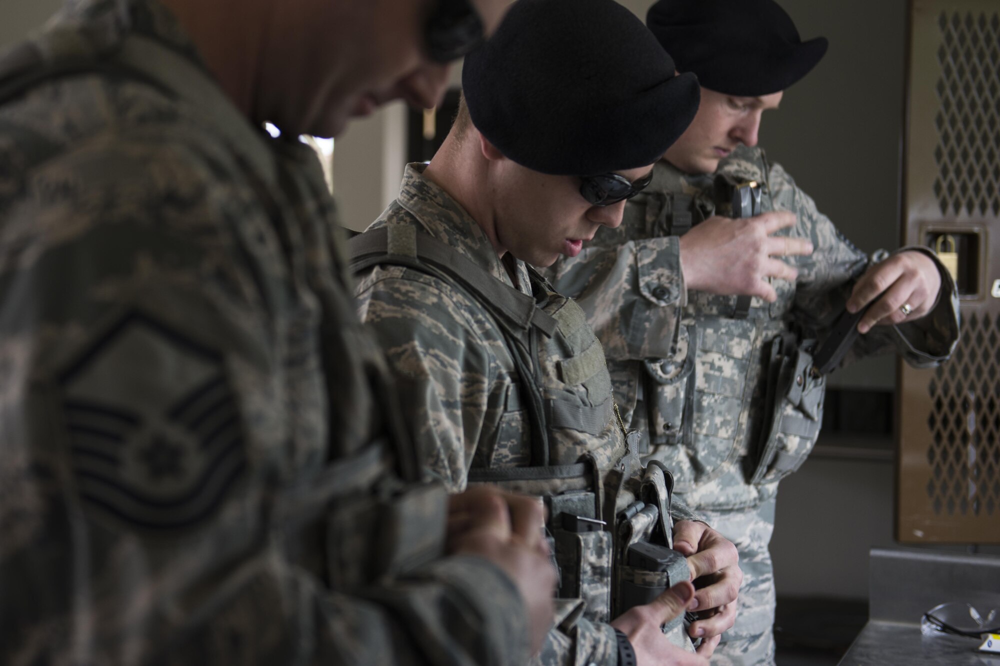 U.S. Airmen with the 354th Security Forces Squadron (SFS) prepare their gear for a small arms competition at Eielson Air Force Base, Alaska, May 17, 2016, as part of National Police Week activities.  The 354th SFS partnered with local law enforcement and U.S. Army counterparts to celebrate Police Week. (U.S. Air Force photo by Staff Sgt. Joshua Turner/Released)