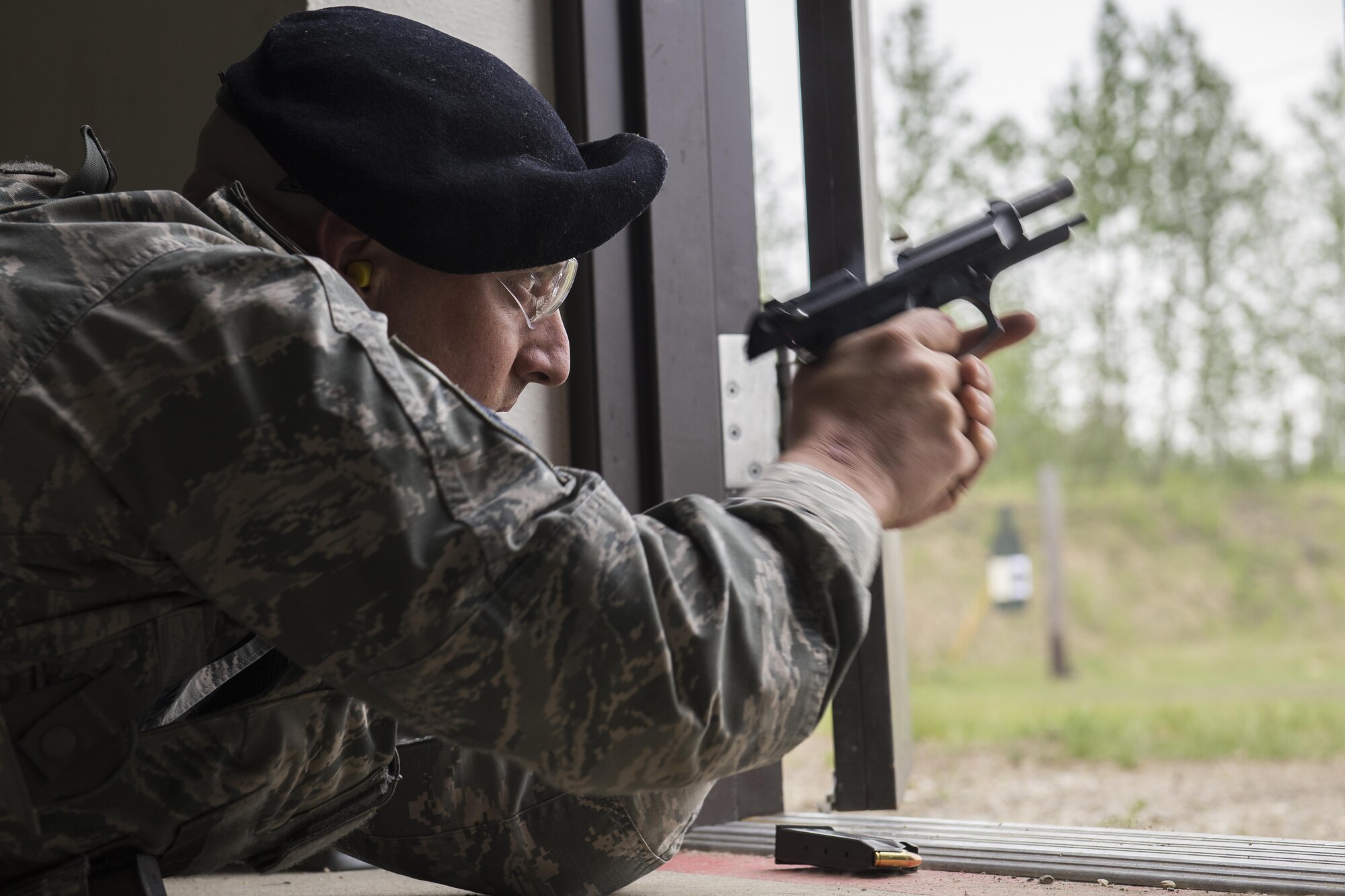 U.S. Air Force Master Sgt. Jeramy Lemons, the 213th Security Force Squadron training manager at Clear Air Force Station, fires an M9 pistol during a small arms competition at Eielson Air Force Base, Alaska, May 17, 2016, as part of National Police Week activities. Police week is a time set aside to remember those who have fallen defending others and learn how law enforcement and security forces members contribute to public safety on a daily basis. (U.S. Air Force photo by Staff Sgt. Joshua Turner/Released)