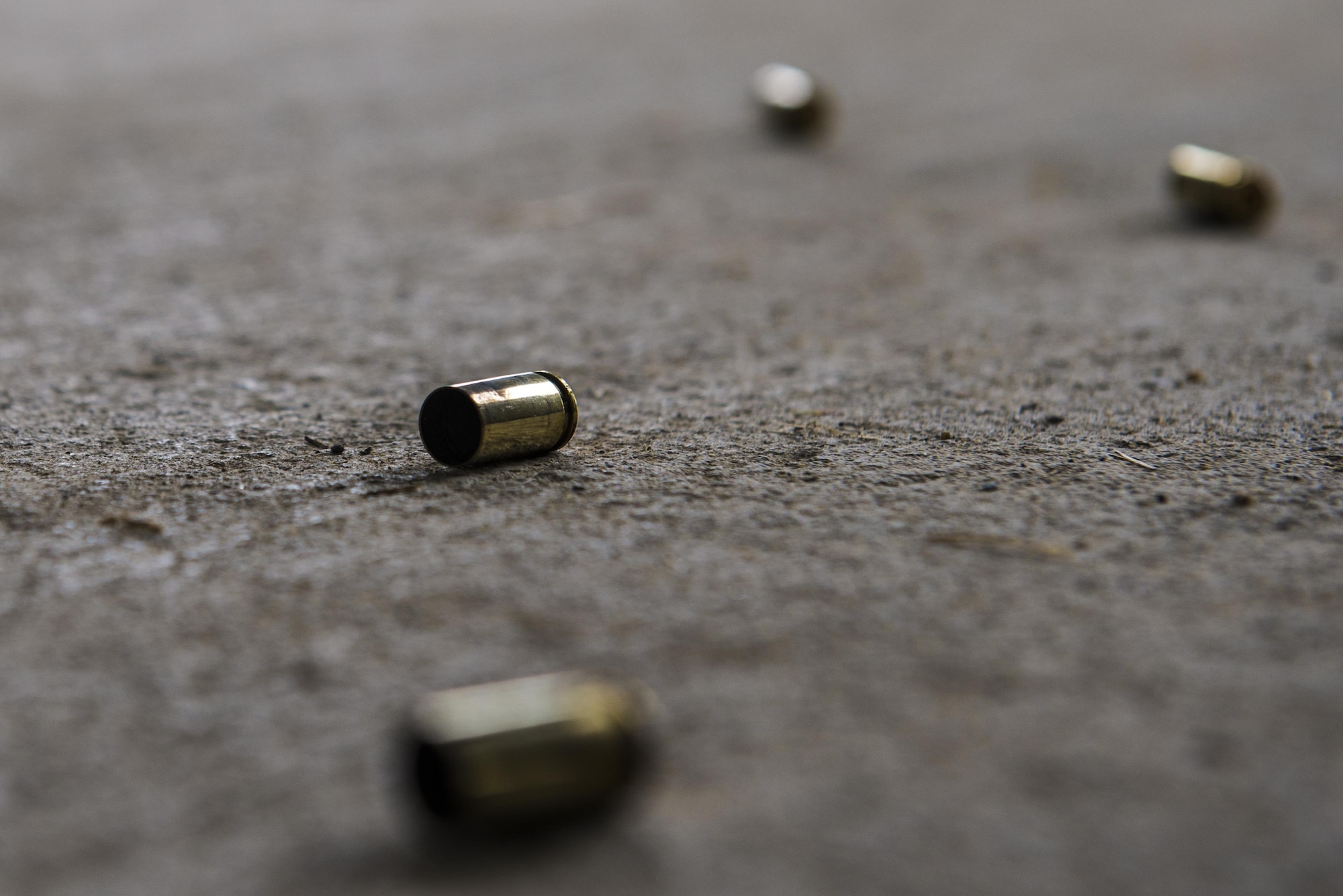 Empty 9mm rounds lie scattered on the ground during a small arms competition at Eielson Air Force Base, Alaska, May 17, 2016, as part of National Police Week activities. Police week is a time set aside to remember those who have fallen defending others and learn how law enforcement and security forces members contribute to public safety on a daily basis. (U.S. Air Force photo by Staff Sgt. Joshua Turner/Released)