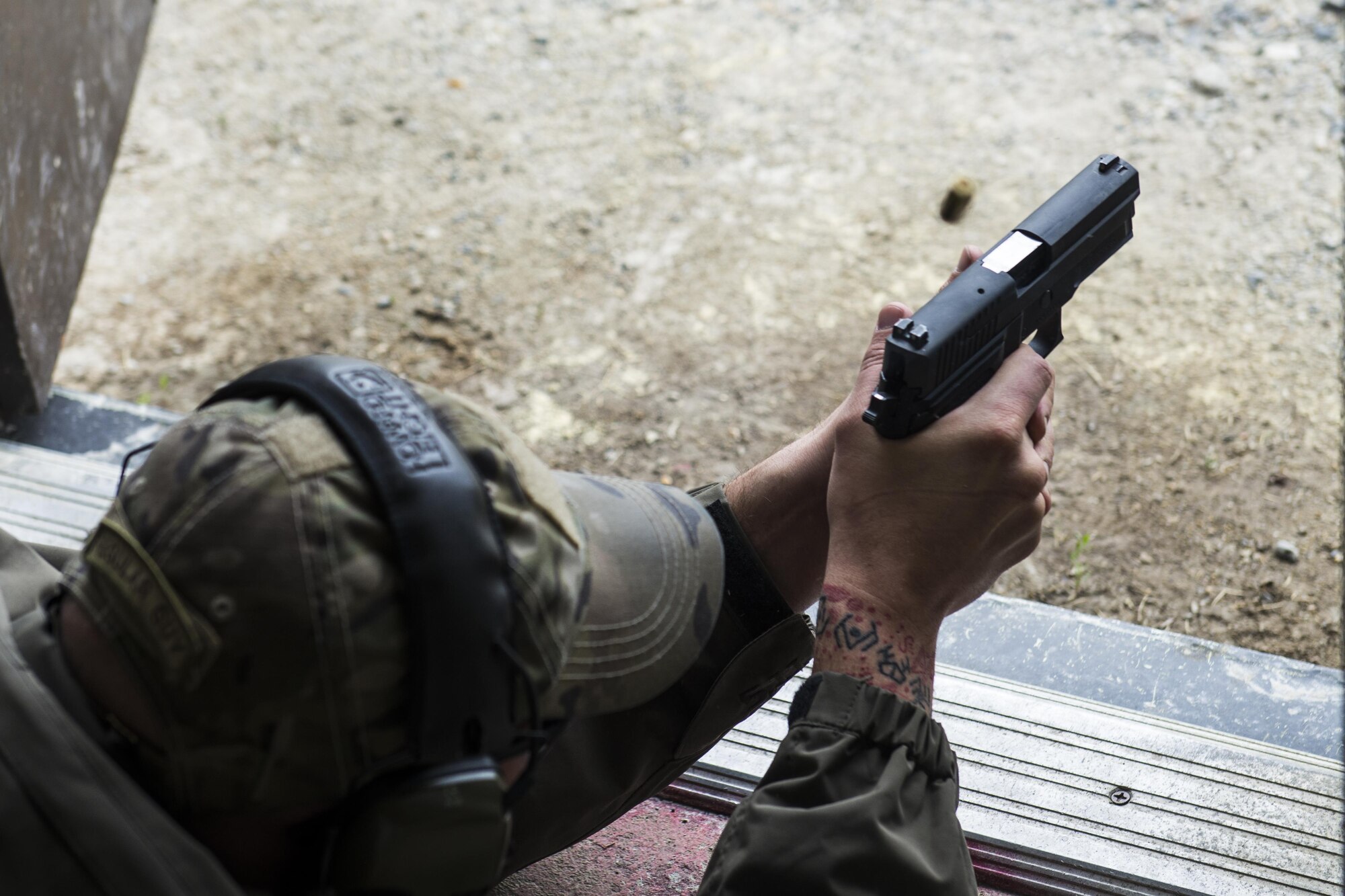 U.S. Air Force office of Special Investigations Special Agent Sam Lee, with Detachment 632, fires a 9mm pistol during a small arms competition at Eielson Air Force Base, Alaska, May 17, 2016, as part of National Police Week activities. Police Week is a time set aside to remember those who have fallen defending others and learn how law enforcement and security forces members contribute to public safety on a daily basis. (U.S. Air Force photo by Staff Sgt. Joshua Turner/Released)