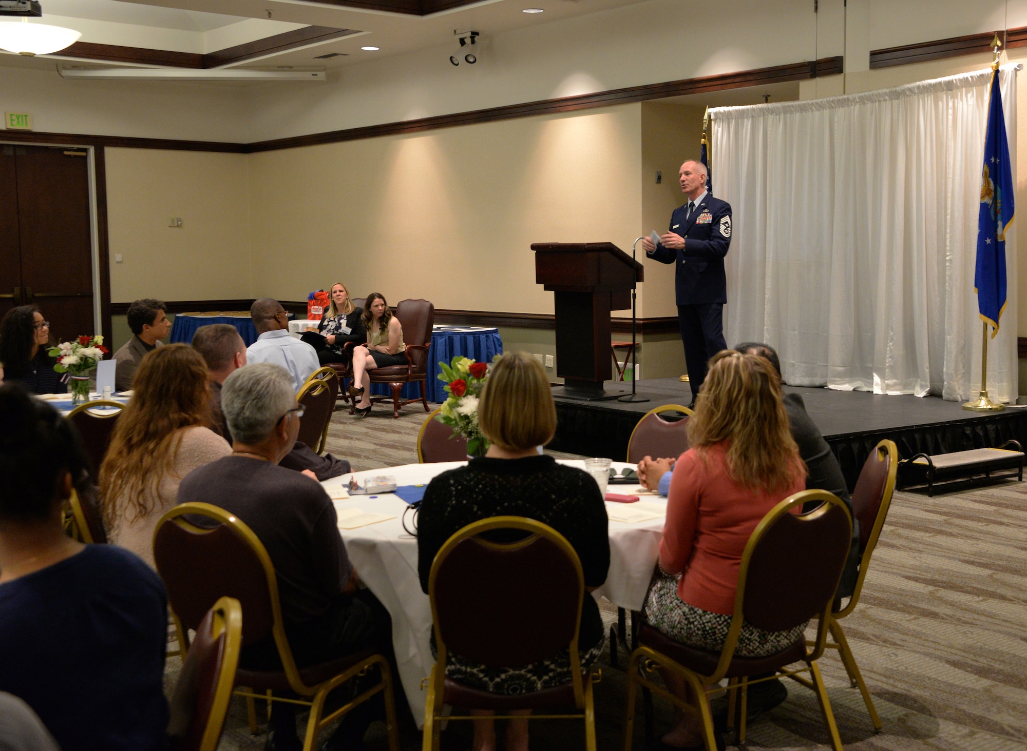 Chief Master Sgt. Alan Boling, 60th Air Mobility Wing command chief, addresses audience members during the annual Officers' and Enlisted Spouses' Clubs Military Dependent Scholarship Award ceremony May 22, 2016, at Travis Air Force Base, Calif. Nineteen scholarships totaling $54,000 were presented during the event to high school and college students, as well as military spouses. Boling congratulated each scholarship recipient and challenged them to do their best as they pursue their goals every day. (U.S. Air Force photo by Tech. Sgt. James Hodgman)