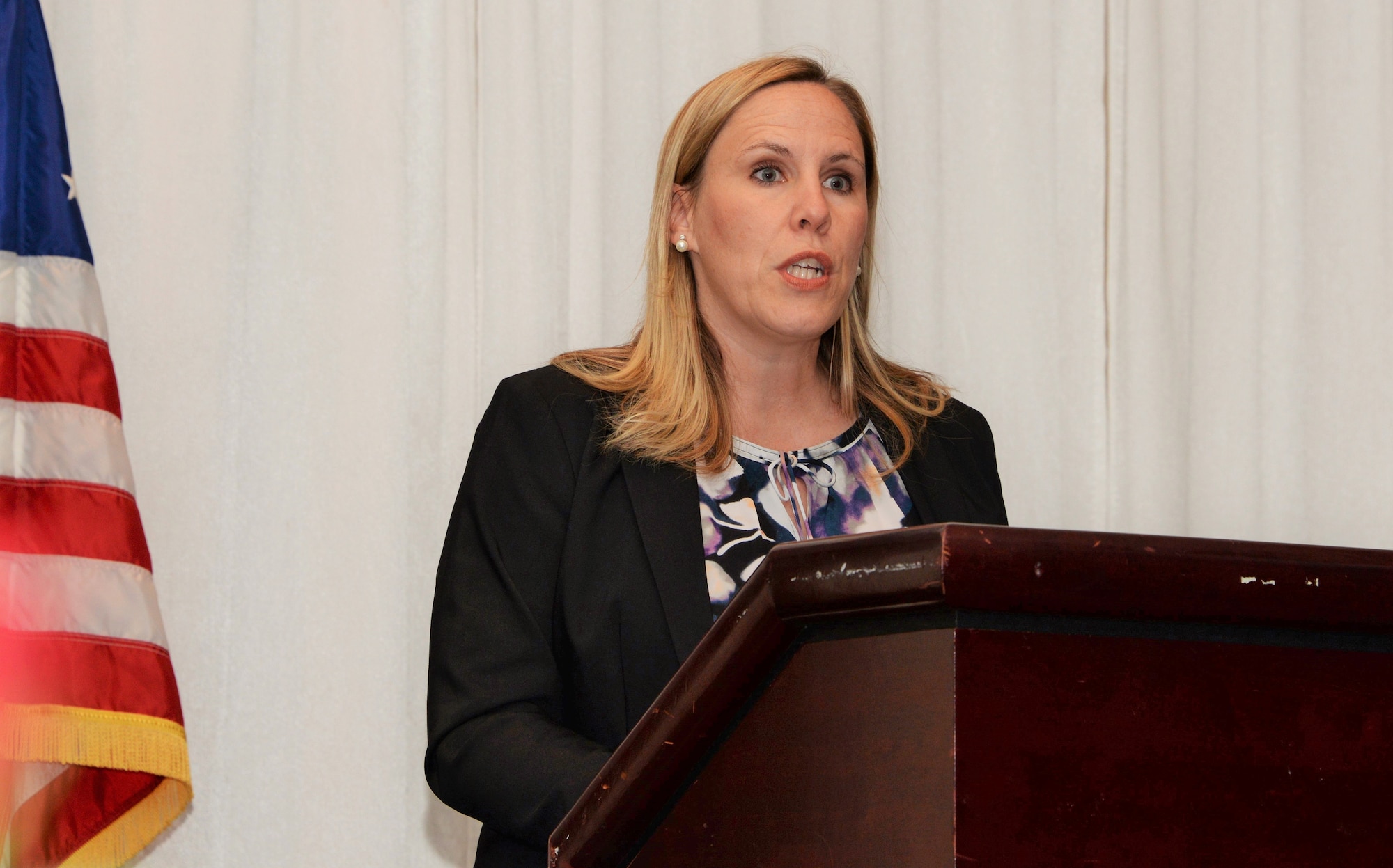 Gretchen Elameto, Travis Officer Spouses’ Club president, addresses audience members during the annual Officers' and Enlisted Spouses' Clubs Military Dependent Scholarship Award ceremony May 22, 2016, at Travis Air Force Base, Calif. Nineteen scholarships totaling $54,000 were presented during the event to high school and college students, as well as military spouses. Elameto said, the scholarships are one way the spouses' clubs give back to the Travis community. (U.S. Air Force photo by Tech. Sgt. James Hodgman)


