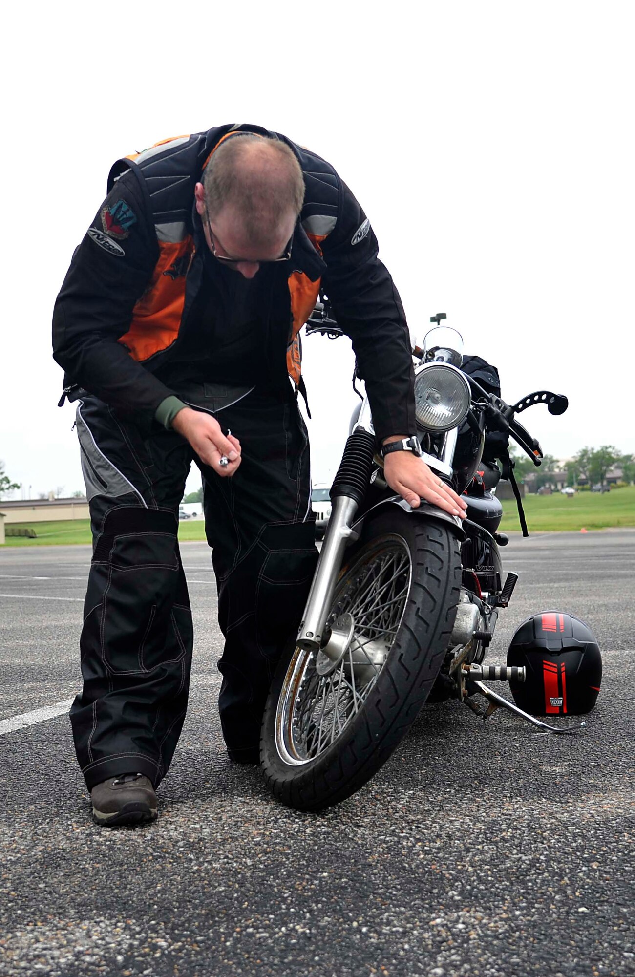 A McConnell Airman checks his motorcycle’s tire pressure before starting the Motorcycle Mentorship Ride, May 20, 2016 at McConnell Air Force Base, Kan. The ride promoted motorcycle safety by giving riders a chance to learn from each other and share their experiences with new riders. (U.S. Air Force photo/Airman Erin McClellan)