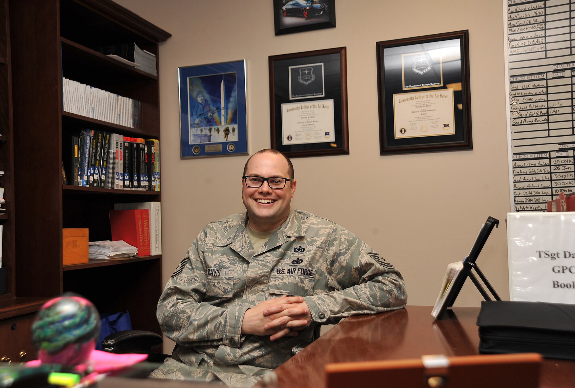 Tech. Sgt. Timothy Davis, 319th Air Base Wing ground safety technician, sits at his desk on Grand Forks Air Force Base, N.D., May 24, 2016. Davis recently received his second Community College of the Air Force degree in safety. (U.S. Air Force photo by Senior Airman Bonnie Grantham/Released)