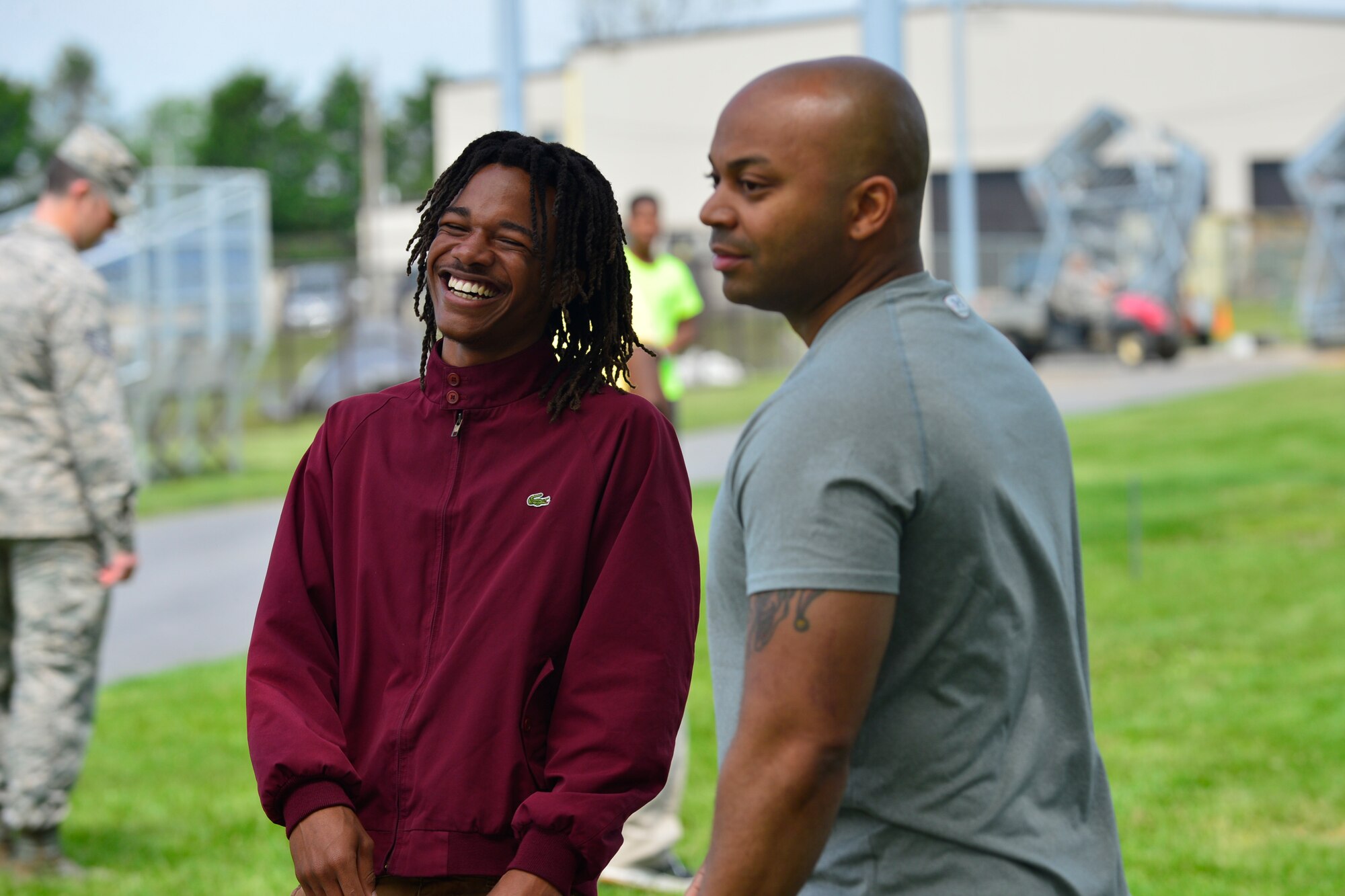 Roosevelt Williams laughs while playing a game of beanbag toss with Master Sgt. Jamie Beard, 436th Security Forces Squadron first sergeant, during the Communities in School program last phase mentoring session May 19, 2016, at Dover Air Force Base, Del. Students of the program were treated to a day of outdoor activities and a barbeque lunch. (U.S. Air Force photo/Senior Airman William Johnson)