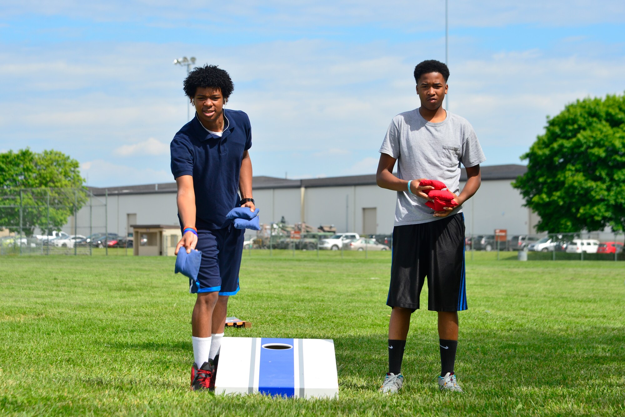 Aj Mingo, left, and Dre Moutrie play a game of beanbag toss during their last phase mentoring session May 19, 2016, at Dover Air Force Base, Del. The two students are part of the Communities in School program that allows students to interact in a professional environment while becoming familiar with Air Force culture. (U.S. Air Force photo/Senior Airman William Johnson)