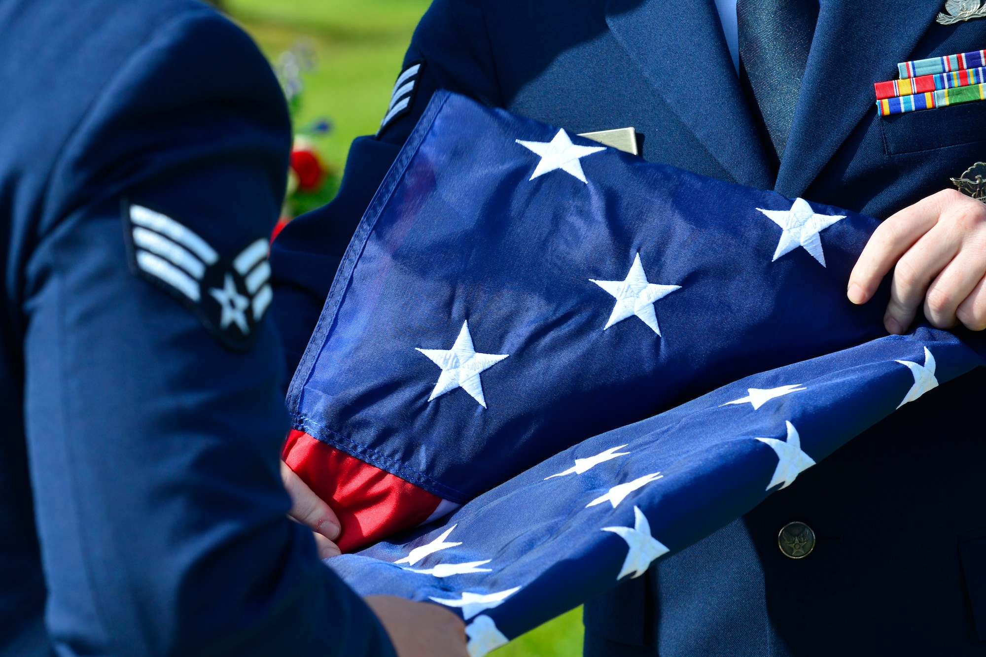 Senior Airman Michael Frisk, 436th Security Forces Squadron response force leader, folds the U.S. Flag during a retreat ceremony commemorating fallen military and civilian law enforcement officers May 20, 2016, outside of the 436th Airlift Wing headquarters building on Dover Air Force Base, Del. The retreat ceremony marked an end to National Police Week. (U.S. Air Force photo/Senior Airman William Johnson)