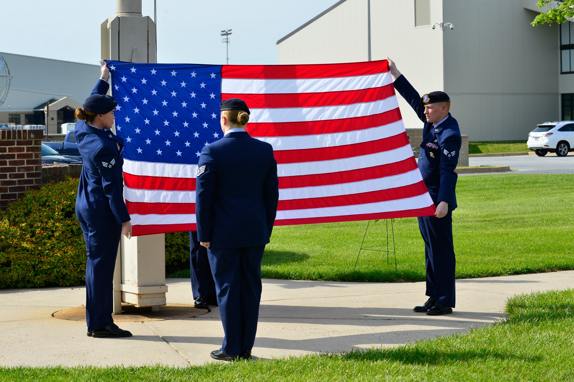 Members of the 436th Security Forces Squadron flag-detail prepare to fold the U.S. Flag during a retreat ceremony commemorating fallen military and civilian law enforcement officers May 20, 2016, outside of the 436th Airlift Wing headquarters building on Dover Air Force Base, Del. The ceremony was attended by local and state law enforcement agencies and culminated National Police Week. (U.S. Air Force photo/Senior Airman William Johnson)