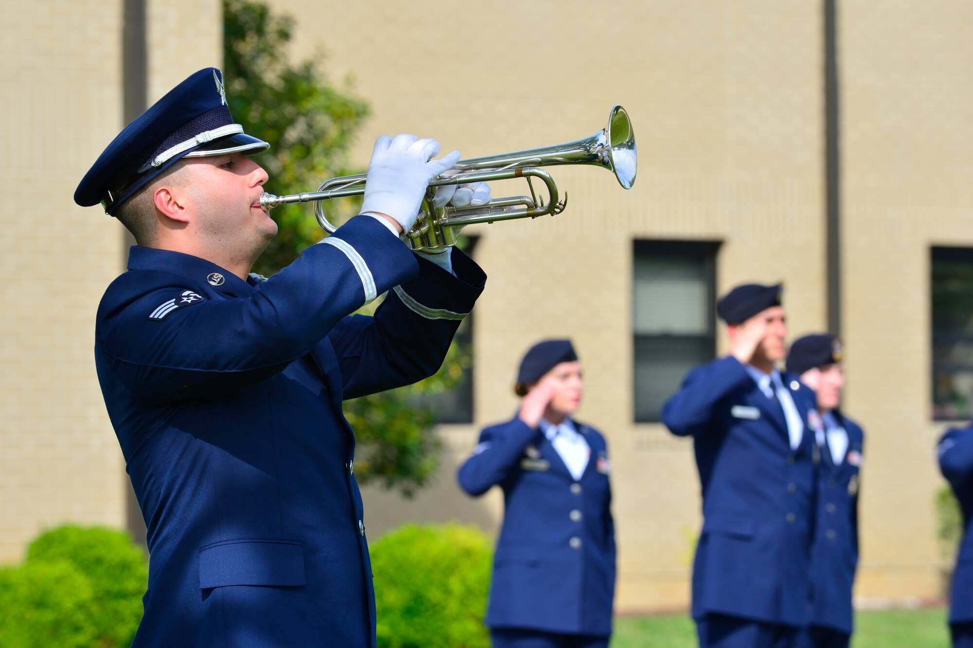 Senior Airman Rye Kelly, Dover Air Force Base Honor Guard member plays taps during a retreat ceremony commemorating fallen military and civilian law enforcement officers May 20, 2016, outside of the 436th Airlift Wing headquarters building on Dover AFB, Del. The retreat was held to commemorate National Police Week. (U.S. Air Force photo/Senior Airman William Johnson)