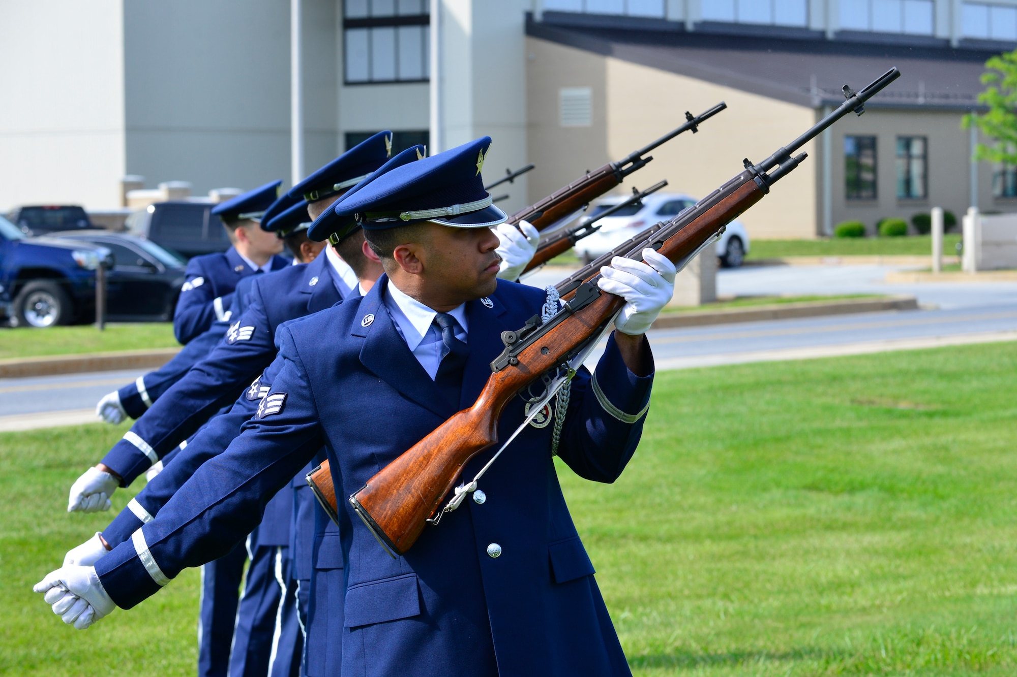 Senior Airman Jorge Rijo, 436th Dover Air Force Base Honor Guard member, fires his M14 in a three-volley salute during a retreat ceremony commemorating fallen military and civilian law enforcement officers May 20, 2016, outside of the 436th Airlift Wing headquarters building on Dover Air Force Base, Del. This seven-gun three-volley firing sequence is commonly referred to as the ”21-gun salute.” (U.S. Air Force photo/Senior Airman William Johnson)