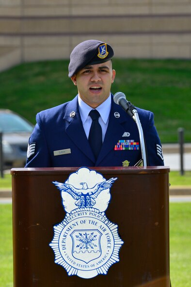 Staff Sgt. Matthew Dubon, 436th Security Forces Squadron Military Working Dog handler, recites the Guardians of the Night poem during a retreat ceremony commemorating fallen military and civilian law enforcement officers May 20, 2016, outside of the 436th Airlift Wing headquarters building on Dover Air Force Base, Del. The poem is an ode to the dedication and sacrifices of MWDs. (U.S. Air Force photo/Senior Airman William Johnson)